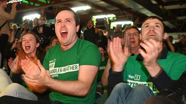 BRISBANE, AUSTRALIA - MAY 21:  Australian Greens volunteers react to favourable election results on May 21, 2022 in Brisbane, Australia. Australians have voted today to elect the 47th Parliament of Australia, with a tight battle between incumbent Prime Minister Scott Morrison of the Coalition party and Labor Leader, Anthony Albanese. The Coalition party has led government since 2013. (Photo by Dan Peled/Getty Images)