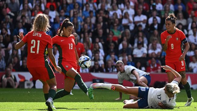 England's midfielder Laura Coombs (2R) plays with a few of the Matildas players at Manchester City. Picture: Ben Stansall / AFP