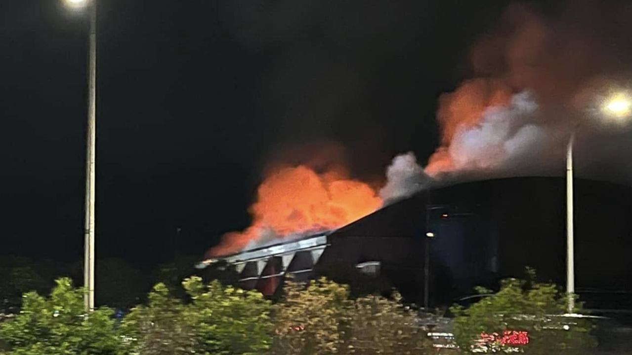 A total of 11 Queensland Fire Department have been tasked with containing a major inferno that's engulfed the main building of the Portsmith Transfer Station. Picture: Tee Kay