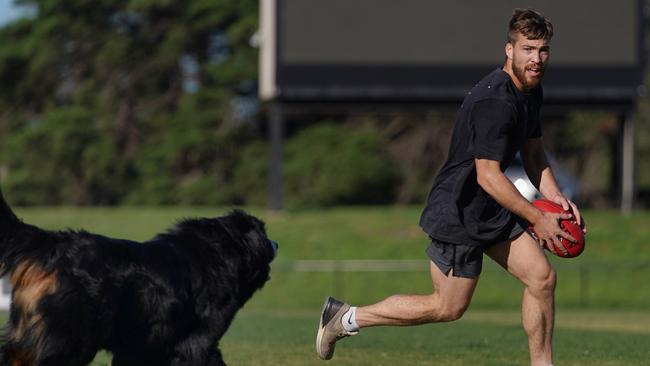 Jack Viney of the Demons trains with his dog Sebastian in Brighton, Friday, May 8, 2020. The AFL has been postponed because of the coronavirus pandemic. Picture: Michael Dodge/AAP