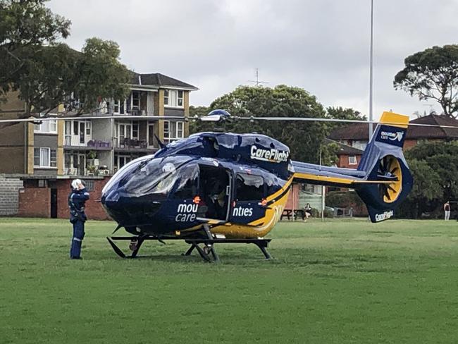 CareFlight helicopter lands at Dee Why oval on Pittwater Rd after a man's mobility scooter toppled into a stationary car at a busy intersection. Picture: Jim O'Rourke.