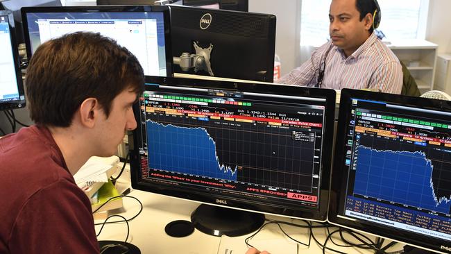 A journalist looks at a Bloomberg terminal showing the drop in the value of the pound following the resignation of Britain's Brexit Minister Dominic Raab last night. Picture: AFP