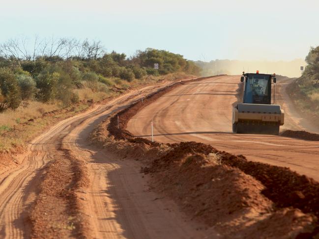 Heavy earthmoving equipment being used in the upgrade of the Mereenie Loop road near Kings Canyon in 2014. Picture: Phil Williams