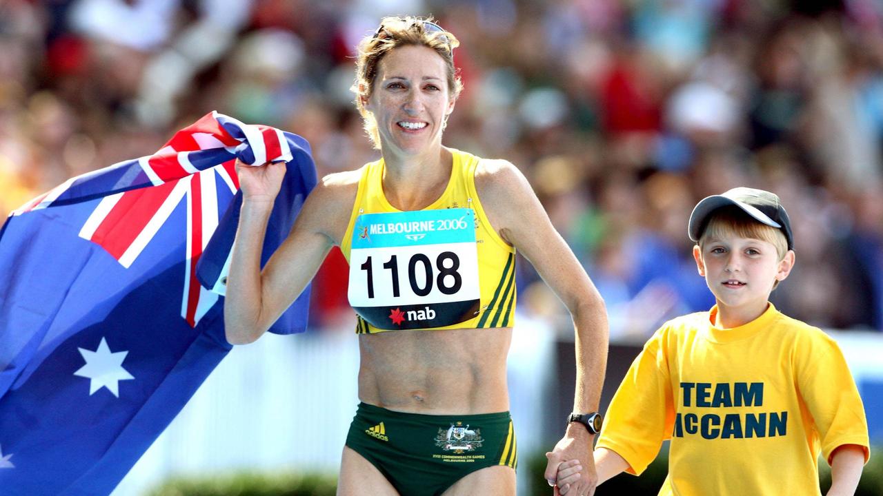 Kerryn McCann with her son Benton after winning the women’s marathon race at the Melbourne Commonwealth Games in 2006.