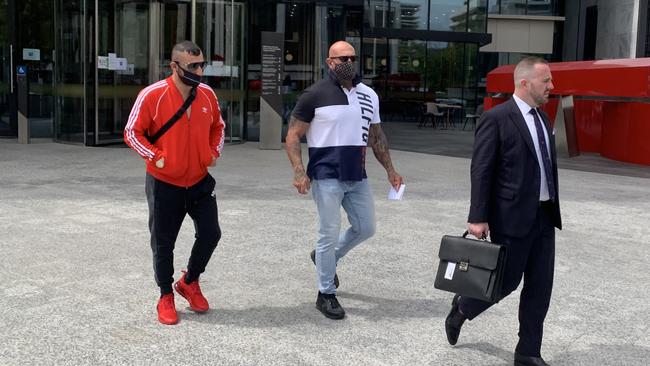 Ali Hassan Bilal (centre) leaves the ACT Law Courts with Lawyer Peter Woodhouse (right, in suit) and an associate (left, in red shirt) Picture: Julia Kanapathippillai