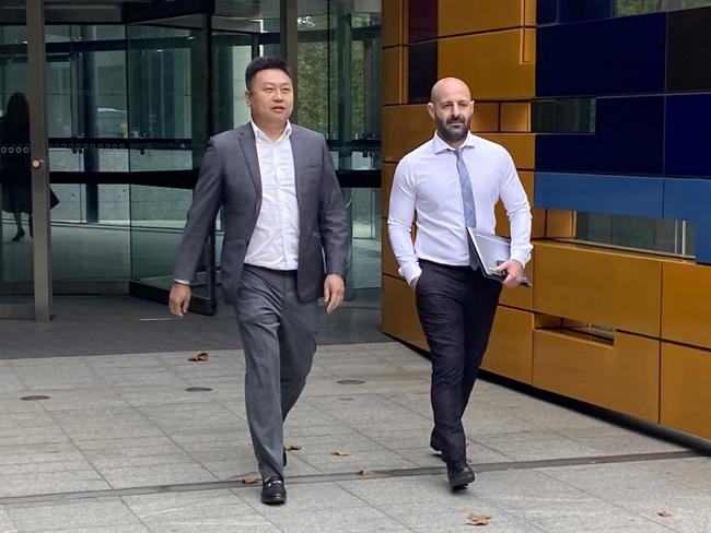 Blockchain Global founder Allan Guo (grey suit) outside the Federal Court with his solicitor George Tsogas (white shirt) on 12 March, 2024.