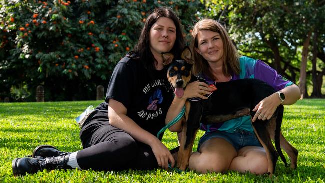 Zach Giles and Maddie Evans say service dog Bobbi - who they adopted and trained with the help of Heart Dogs NT - is a life-changer. Picture: Pema Tamang Pakhrin