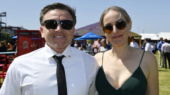 Caulfield Guineas horse race meeting, Caulfield, Victoria, Saturday 12th October 2024. Faces in the crowd. Pictured enjoying the race meeting are Jay Allen (OAM) and Eve Brown. Picture: Andrew Batsch