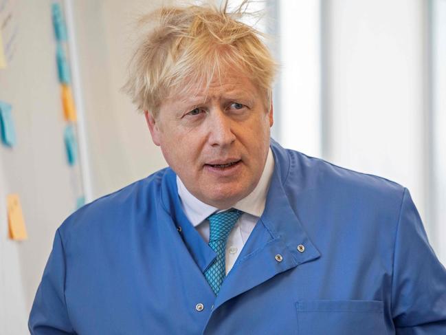 (FILES) In this file photo taken on March 06, 2020 Britain's Prime Minister Boris Johnson visits to the Mologic Laboratory in the Bedford technology Park, north of London . - Britain's Prime Minister Boris Johnson appeared to be on the road to recovery as Downing Street said the Prime Minister had returned to the ward at St Thomas' Hospital after spending three nights in the intensive care unit. (Photo by Jack Hill / POOL / AFP)