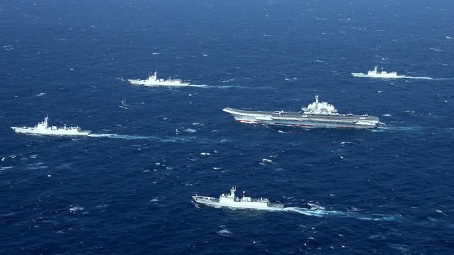 A Chinese navy formation, including the aircraft carrier Liaoning, during military drills in the South China Sea in 2017. Picture: STR/AFP