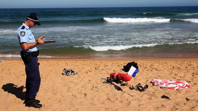 A man has died after being pulled from the water at North Narrabeen Beach on Monday afternoon. Police officers set up a crime scene and were guarding the man's belongings. Picture: Toby Zerna