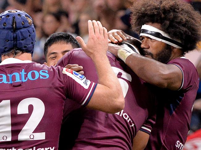 BRISBANE, AUSTRALIA - MARCH 14: Lukhan Salakaia-Loto of the Reds is congratulated by team mates after scoring a try during the round seven Super Rugby match between the Reds and the Bulls on March 14, 2020 in Brisbane, Australia. (Photo by Bradley Kanaris/Getty Images)