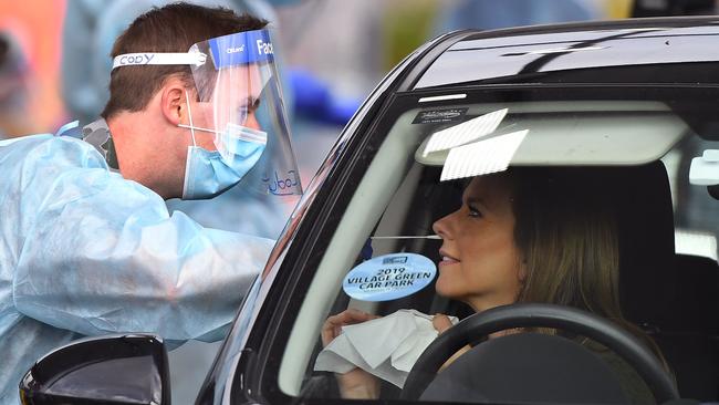 A member of the Australian Defence Force takes a swab sample at a drive-through COVID-19 coronavirus testing station in the Melbourne suburb of Fawkner on Thursday. Picture: AFP