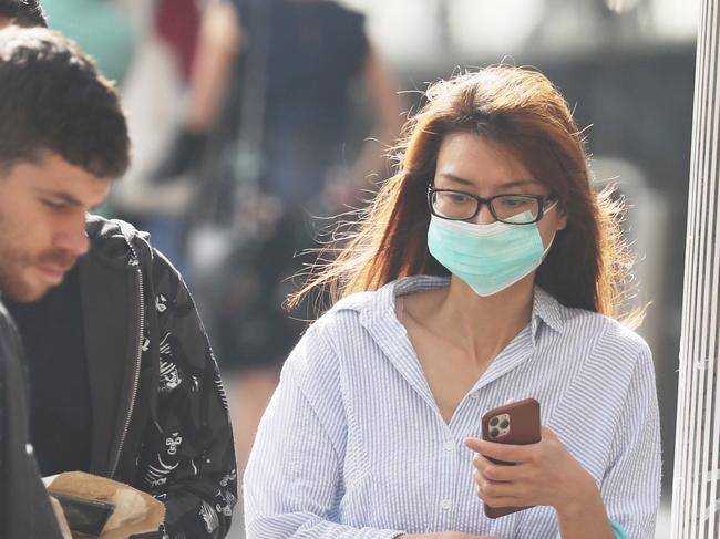 Sydneysiders protecting themselves against the spread of coronavirus. Picture: John Grainger