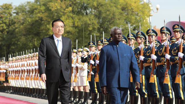 Chinese Premier Li Keqiang holds a welcoming ceremony for Solomon Islands' Prime Minister Manasseh Sogavare ahead of their talks at the Great Hall of the People in Beijing in 2019.