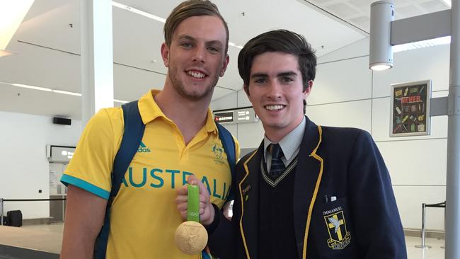 Swimmer Kyle Chalmers at Adelaide Airport with Immanuel College student Sam McCabe . Picture : Tricia Watkinson