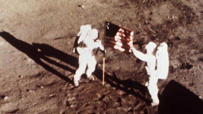 Apollo 11 astronauts Neil Armstrong and Edwin E. "Buzz" Aldrin, the first men to land on the moon, plant the U.S. flag on the lunar surface on July 20, 1969. Picture: AP/NASA.