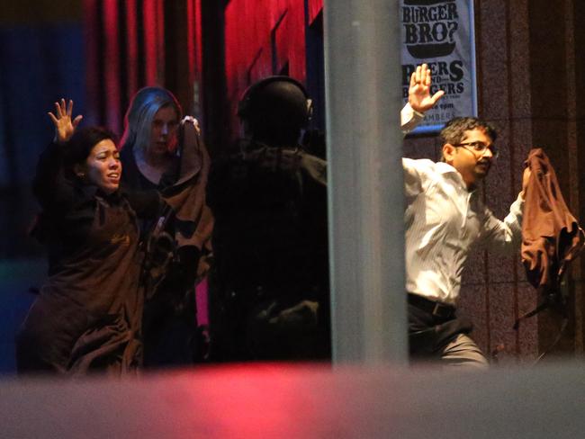 Monis fired at hostages as they ran to safety. Picture: AP Photo/Rob Griffith