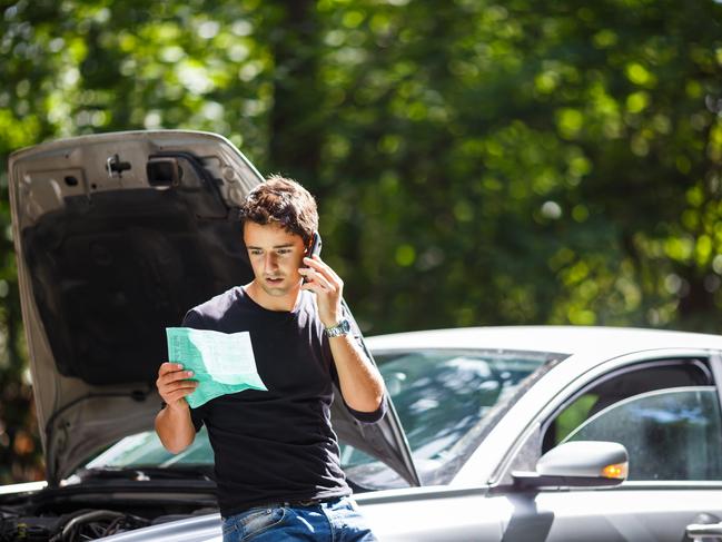 MOTORING: CAR BREAKDOWN Picture: istock Handsome young man calling for assistance with his car broken down by the roadside