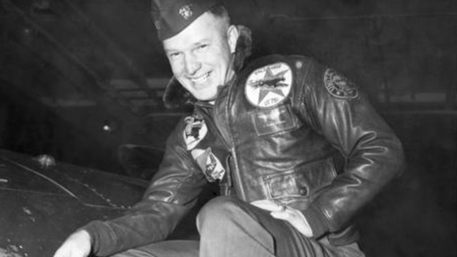 Lt. Royce Williams, USN, points out battle damage to F9F-5 Panther aboard USS Oriskany on 18 Nove