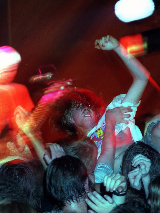 A crowd-surfer enjoys the music.