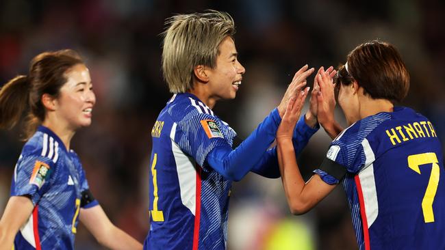 Mina Tanaka (C) celebrates with Hinata Miyazawa (R) after scoring against Zambia. (Photo by Catherine Ivill/Getty Images)