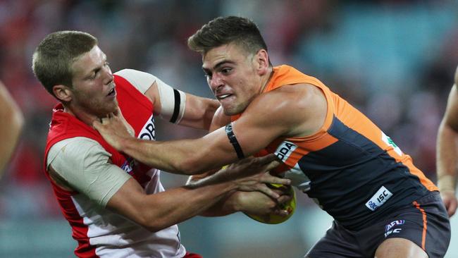 A young Stephen Coniglio tries to shrug Dan Hannebery. Pic. Phil Hillyard