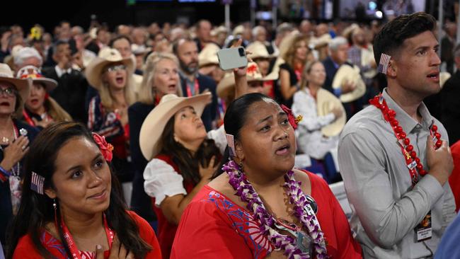 Attendees wear an US flag patch on they ear as they sing the National Anthem on the last day of the 2024 Republican National Convention in Milwaukee, Wisconsin. Picture: Jim Watson/AFP/ AFP)