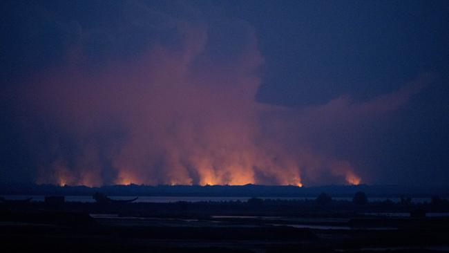 Smoke and flames in Myanmar are seen from the Bangladeshi side of the border near Cox's Bazar's Teknaf area, Sunday, Sept. 3, 2017. Picture: Bernat Armangue