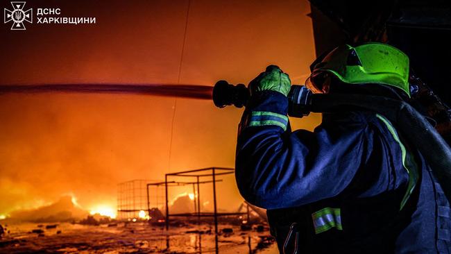 A Ukrainian firefighter extinguishes a blaze in a private enterprise facility following a Russian strike in Kharkiv. Picture: AFP.
