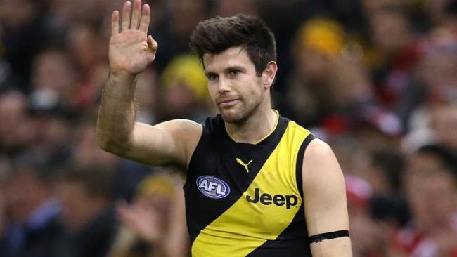 Trent Cotchin wearing a black armband.