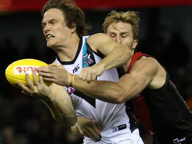 Jared Polec tries to get a bandball away under pressure.