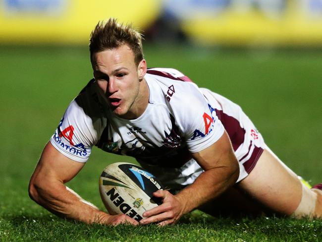 Manly's Daly Cherry-Evans kicks ahead to score a try during the Manly v Wests Tigers rugby league game at Brookvale Oval, Sydney. Pic Brett Costello