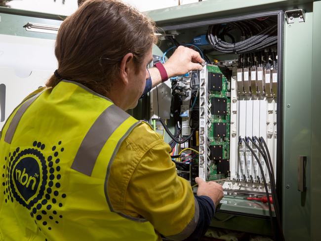 An NBN Co. technician handles hardware in a fibre distribution cabinet. Picture: Cole Bennetts