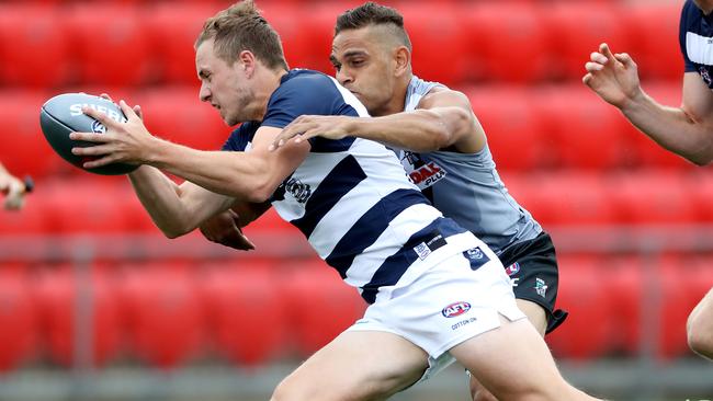 Geelong’s Mitch Duncan and Port Adelaide’s Dom Barry play AFLX. Picture: Calum Robertson