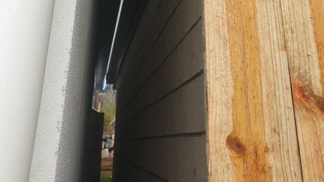 The gap between the two houses was boarded up with fence palings.