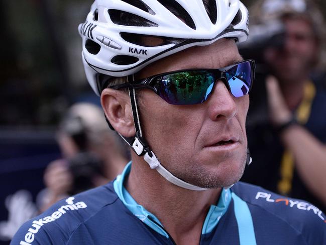 US cyclist Lance Armstrong gets ready in Rodez, southwest France, prior to ride a stage of The Tour De France for a leukaemia charity, a day ahead of the competing riders, on July 17, 2015. For the first time since he was stripped of his seven Tour de France titles, Armstrong rode a stage of the famous race for charity. The charity, the brainchild of former England football international Geoff Thomas who beat leukaemia, aims to raise "around £1 million" (1.4 million euros, $1.5m) mainly via sponsorship garnered by the 10 other amateur cyclists riding the route. AFP PHOTO / STEPHANE DE SAKUTIN