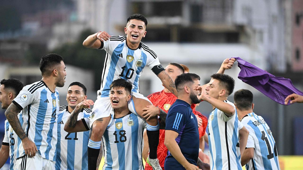 Argentine players celebrate after defeating Brazil and qualifying to the 2024 Paris Olympic Games during the Venezuela 2024 CONMEBOL Pre-Olympic Tournament football match between Brazil and Argentina at the Brigido Iriarte stadium in Caracas on February 5, 2024. (Photo by Federico Parra / AFP)