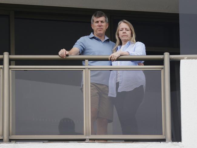 Janine and Wayne Smith, who have to isolate for seven days, on the balcony of their 13th floor apartment. They gained an order from the government watchdog for their dog to be allowed to enter a lift at Trafalgar Towers. Picture: Lachie Millard