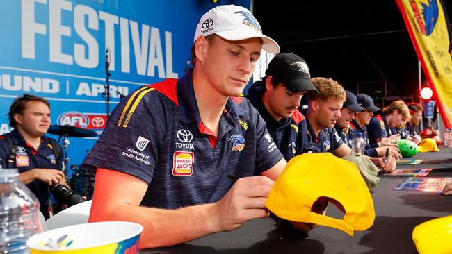 Captain Jordan Dawson signs autographs during the Gather Round Footy Festival in Adelaide. PictureL Dylan Burn