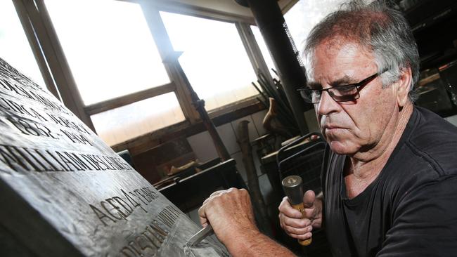 Jim Deslandes with his Grandfather Charles Deslandes’ headstone. Picture: Mark Wilson