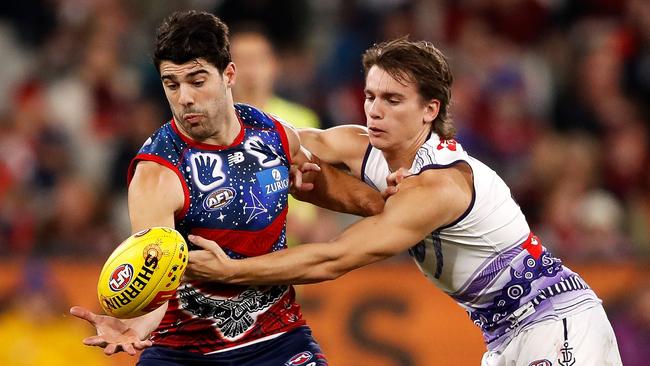 MELBOURNE, AUSTRALIA - MAY 28: Christian Petracca of the Demons and Caleb Serong of the Dockers compete for the ball during the 2022 AFL Round 11 match between the Narrm Demons and the Fremantle Dockers at the Melbourne Cricket Ground on May 28, 2022 in Melbourne, Australia. (Photo by Dylan Burns/AFL Photos via Getty Images)