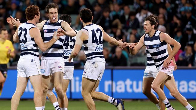 Geelong teammates run to Jeremy Cameron as he gets the Cats back on track. Picture: AFL Photos via Getty Images