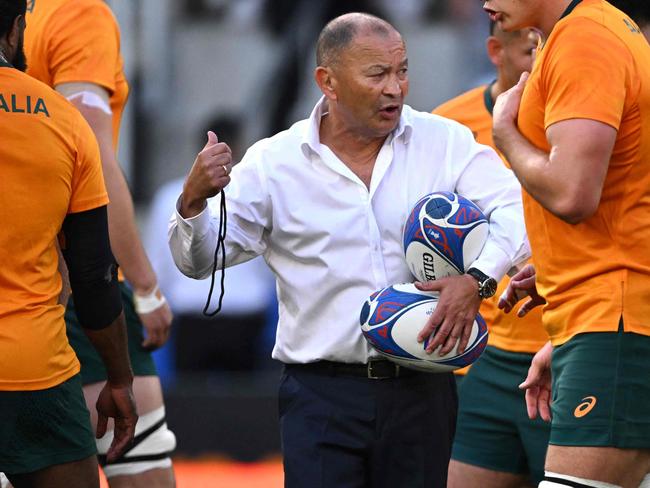 Australia's head coach Eddie Jones leads warm up prior to the  France 2023 Rugby World Cup Pool C match between Australia and Portugal at Stade Geoffroy-Guichard in Saint-Etienne, south-eastern France, on October 1, 2023. (Photo by SEBASTIEN BOZON / AFP)