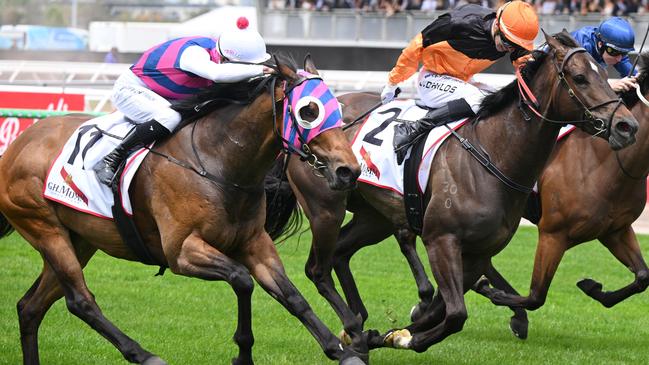 MELBOURNE, AUSTRALIA - NOVEMBER 02: Jordan Childs riding Maharba defeats Jye McNeil riding Rey Magnerio (L) and Charm Stone (r) in Race 3, the G.h. Mumm Rising Fast Stakes - Betting Odds  during 2024 Penfolds Victoria Derby Day at Flemington Racecourse on November 02, 2024 in Melbourne, Australia. (Photo by Vince Caligiuri/Getty Images)