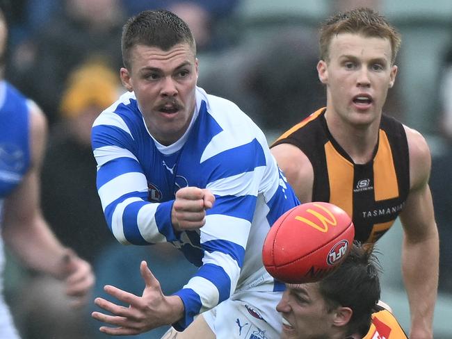 LAUNCESTON, AUSTRALIA - AUGUST 24: Cameron Zurhaar of the Kangaroos is tackled by Dylan Moore of the Hawks during the round 24 AFL match between Hawthorn Hawks and North Melbourne Kangaroos at University of Tasmania Stadium, on August 24, 2024, in Launceston, Australia. (Photo by Steve Bell/AFL Photos/via Getty Images)