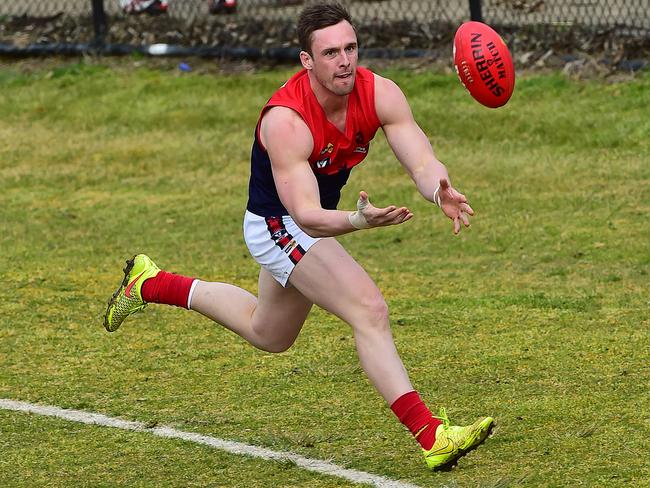 Pictured is Peninsula Football Netball League round 15 game of Australian Rules Football Langwarrin ( blue and white with blue shorts ) versus Mt Eliza ( red, white, blue with white shorts ) at Lloyd Park in Langwarrin. Justin Van Unen leads but the ball is out of bounds. Picture: Derrick den Hollander