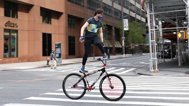 A man practises bike tricks on 7th Avenue during the coronavirus pandemic in New York in April. Picture: Getty Images