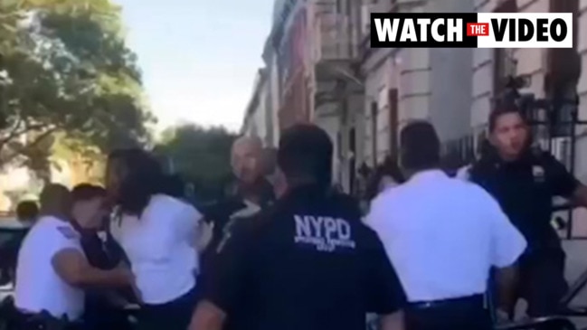 A shocking video shows an NYPD cop punching a woman in the face, causing he...