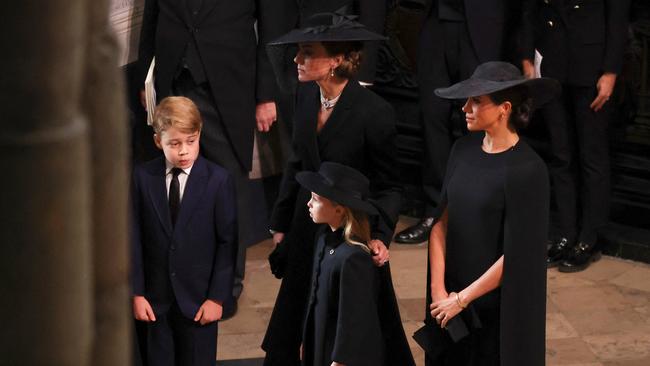 Catherine, Princess of Wales, Princess Charlotte of Wales, Prince George of Wales and Meghan, Duchess of Sussex.